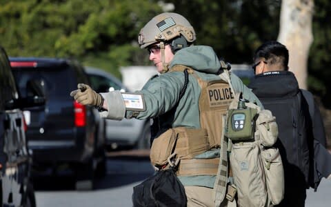 A member of the US Secret Service takes his position as Mr Trump arrives at Walter Reed National Military Medical Center - Credit: REUTERS/Yuri Gripas