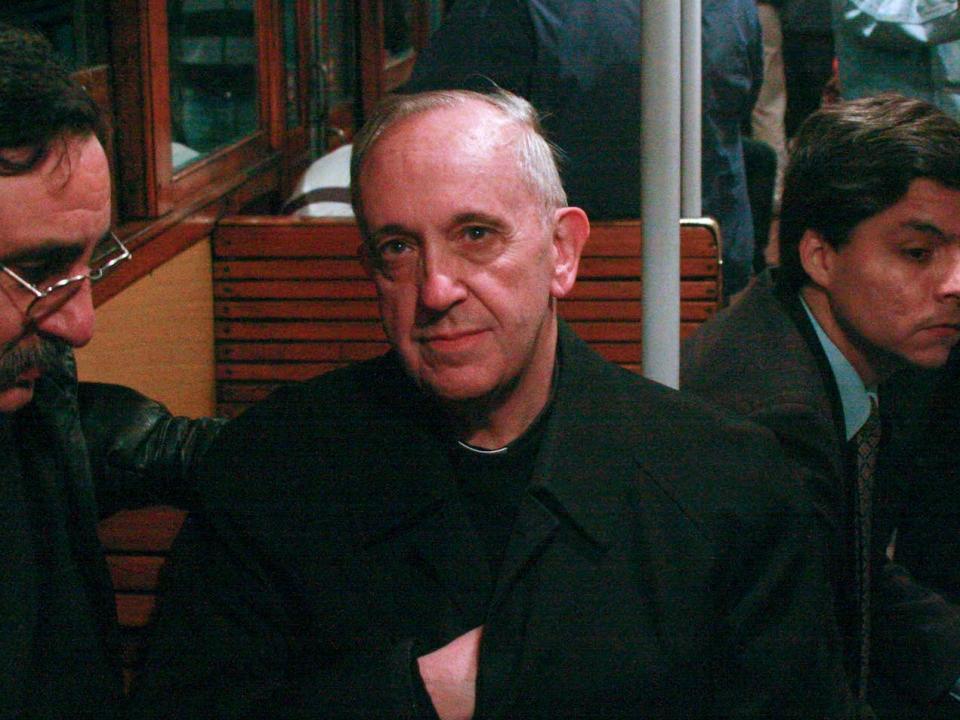 A 2008 file photo of Argentina's Cardinal Jorge Mario Bergoglio, who would later become Pope Francis, riding a crowded subway in Argentina. He wears a black shirt.