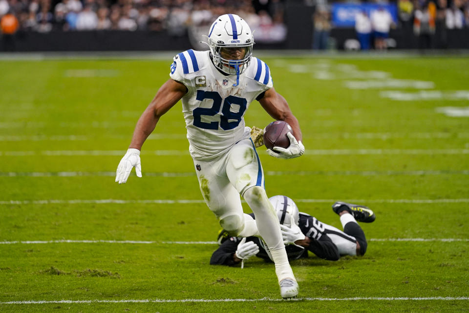 Indianapolis Colts running back Jonathan Taylor (28) gets past Las Vegas Raiders cornerback Rock Ya-Sin (26) in the first half of an NFL football game in Las Vegas, Sunday, Nov. 13, 2022. (AP Photo/Matt York)