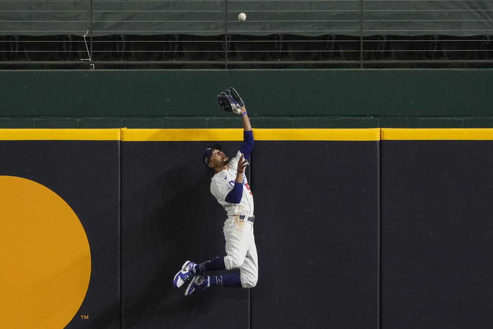 Los Angeles Dodgers right fielder Mookie Betts robs Atlanta Braves' Freddie Freeman of a home run during the fifth inning in Game 7 of a baseball National League Championship Series Sunday, Oct. 18, 2020, in Arlington, Texas. (AP Photo/Tony Gutierrez)