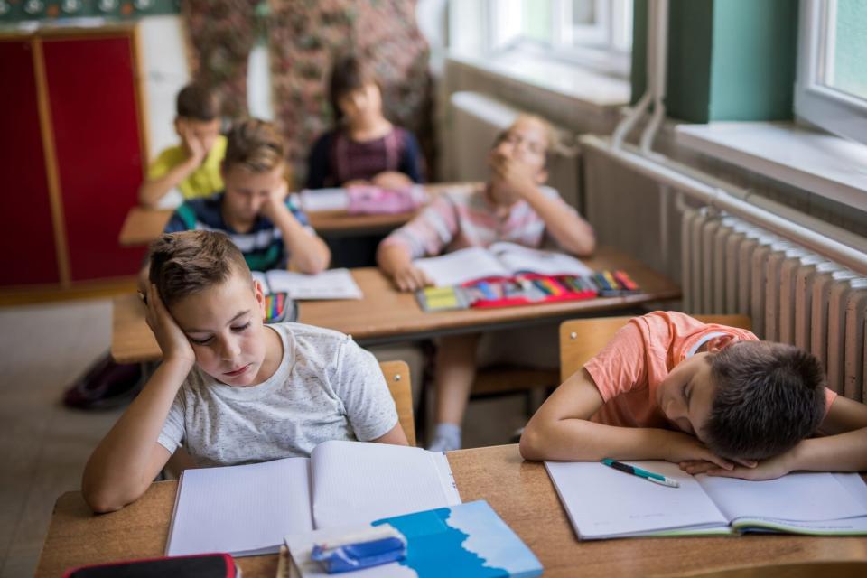 An image of kids sleeping in class.