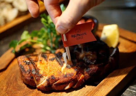 A chef prepares a pork steak at HyLife Pork Table, a pork dish restaurant operated by Canadian pig farmer and pork processor HyLife, at Daikanyama district in Tokyo, Japan October 31, 2016. REUTERS/Issei Kato