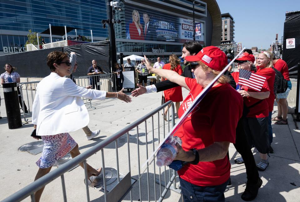 Former television news anchor and failed Republican Arizona gubernatorial candidate Kari Lake shakes hands with Trump supporters outside the Fiserv Forum in Milwaukee, Wisconsin (AFP via Getty Images)