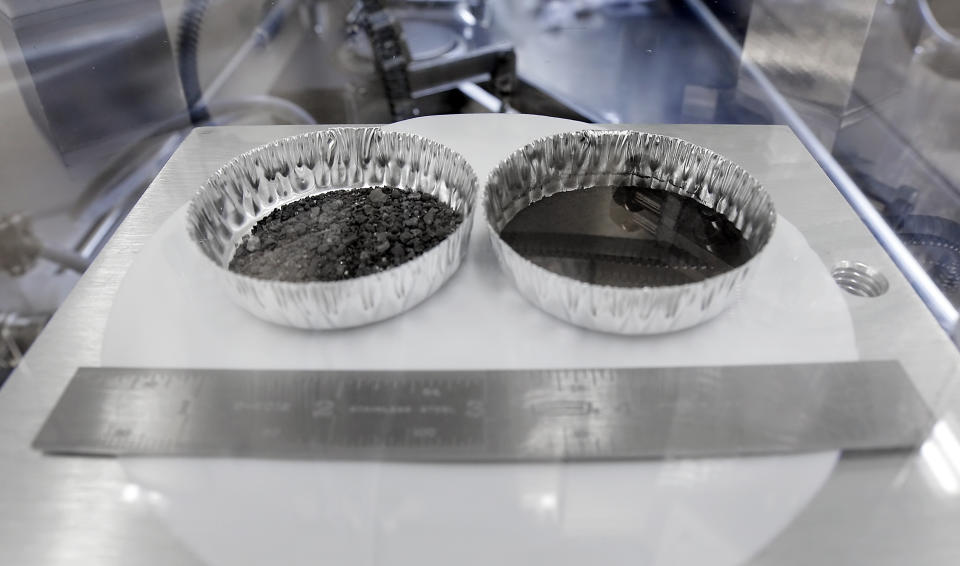 Two separate 2 inch foil pans hold lunar dirt, from the last shovel full collected by Neil Armstrong on the Apollo 11, in the lunar lab at the NASA Johnson Space Center Monday, June 17, 2019, in Houston. (AP Photo/Michael Wyke)