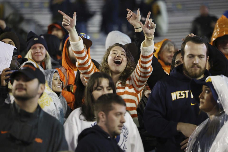 An Oklahoma State fan cheers during the second half of an NCAA college football game against West Virginia, Saturday, Oct. 21, 2023, in Morgantown, W.Va. (AP Photo/Chris Jackson)