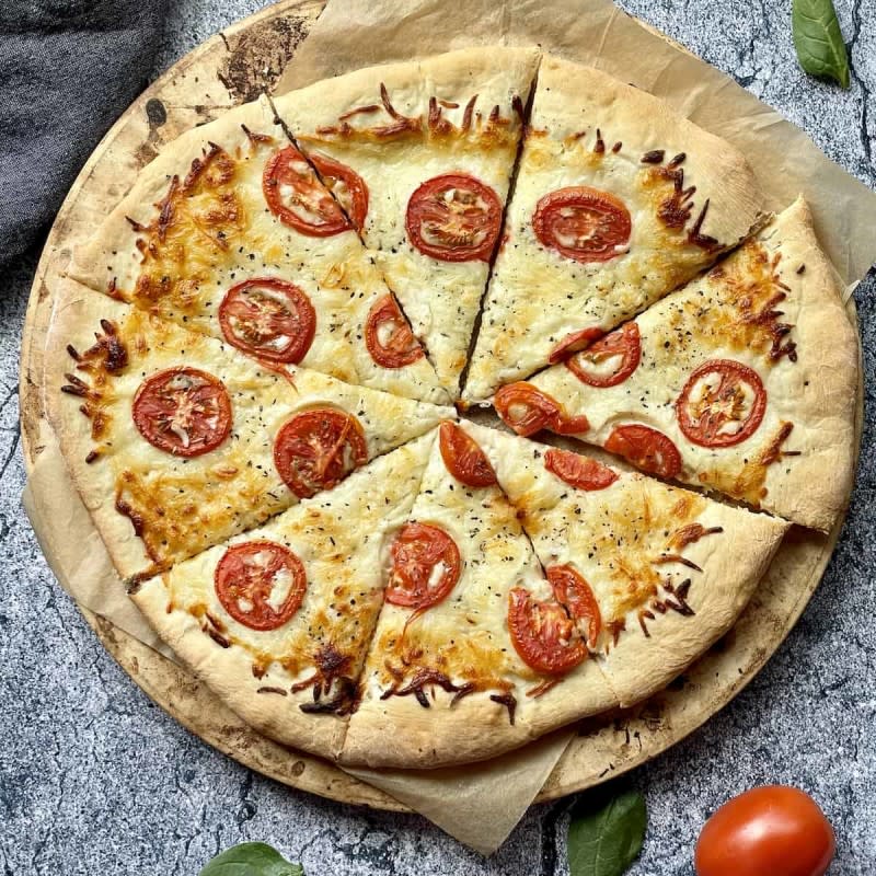 <p>Tasty Oven</p><p>White pizza with tomato and basil makes a quick and simple delicious lunch or dinner that never disappoints.</p><p><strong>Get the recipe: <a href="https://tastyoven.com/white-pizza-with-tomato-and-basil/" rel="nofollow noopener" target="_blank" data-ylk="slk:White Pizza with Tomato and Basil;elm:context_link;itc:0;sec:content-canvas" class="link ">White Pizza with Tomato and Basil</a></strong></p>