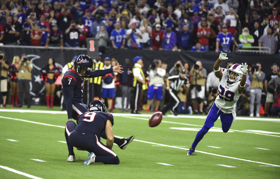 Houston Texans kicker Ka'imi Fairbairn (7) kicks a game-winning 28-yard field goal as Buffalo Bills cornerback Kevin Johnson (29) tries to block the kick during overtime of an NFL wild-card playoff football game Saturday, Jan. 4, 2020, in Houston. The Texans won 22-19. (AP Photo/Eric Christian Smith)