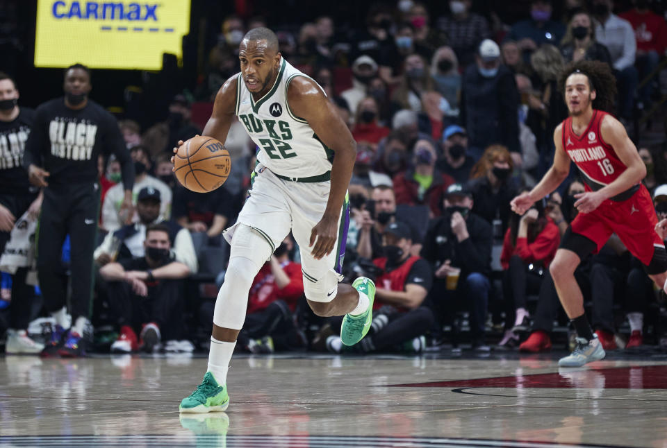 Milwaukee Bucks forward Khris Middleton brings the ball up against the Portland Trail Blazers during the first half of an NBA basketball game in Portland, Ore., Saturday, Feb. 5, 2022. (AP Photo/Craig Mitchelldyer)