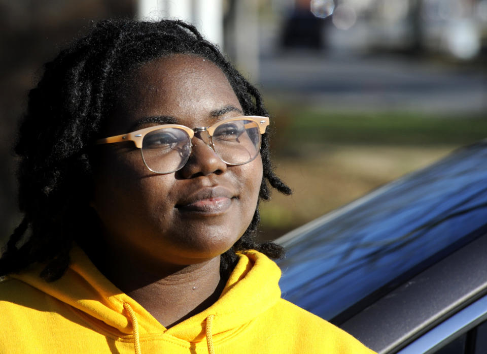 Unique Morgan Dunston pauses in her hometown of Albertville, Ala., on Wednesday, Dec. 9, 2020, before a protest against a Confederate monument and flag located on the lawn of the Marshall County Courthouse. Transformed by leaving the virtually all-white town where she grew up, Dunston has been leading the demonstrations since August. (AP Photo/Jay Reeves)