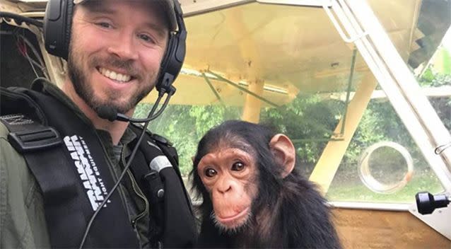 Virunga National Park pilot Anthony Caere with baby chimp Mussa. Source: Lwiro Primates/ Facebook