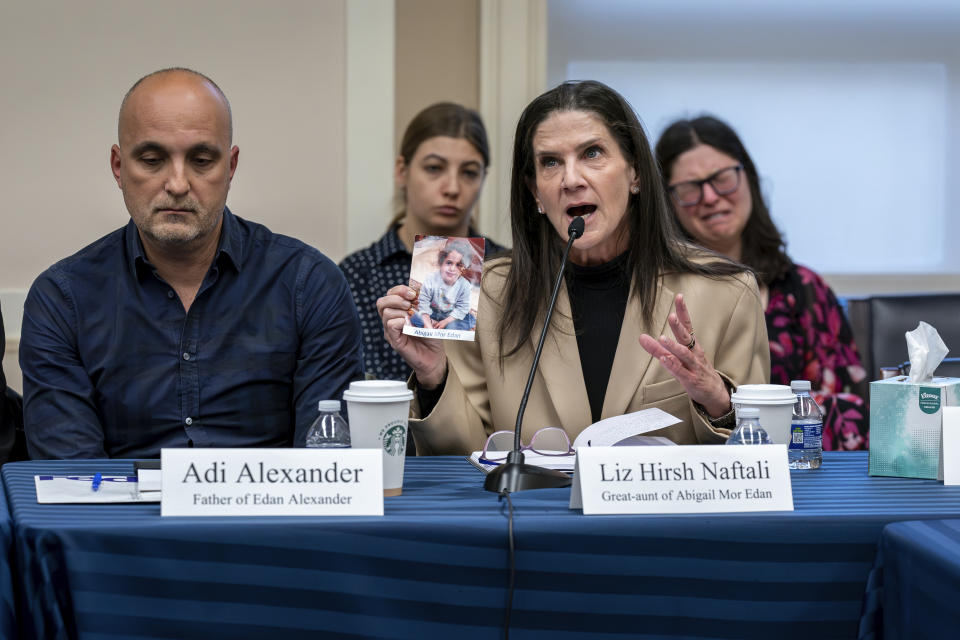 Adi Alexander, left, the father of Eden Alexander, who was taken hostage by Hamas during the Oct. 7 attack on Israel, listens to Liz Hirsh Naftali, right, great aunt of Abigail More Edan, who was kidnapped but returned in the recent hostage release in Israel, as families and victims of the Hamas attacks meet with the House Foreign Affairs Committee, at the Capitol in Washington, Wednesday, Nov. 29, 2023. (AP Photo/J. Scott Applewhite)