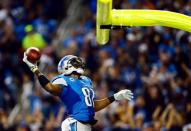 Detroit Lions wide receiver Calvin Johnson (81) dunks the football over the goal post after scoring a touchdown during the third quarter of a NFL football game against the Green Bay Packers on Thanksgiving at Ford Field. Mandatory Credit: Andrew Weber-USA TODAY Sports