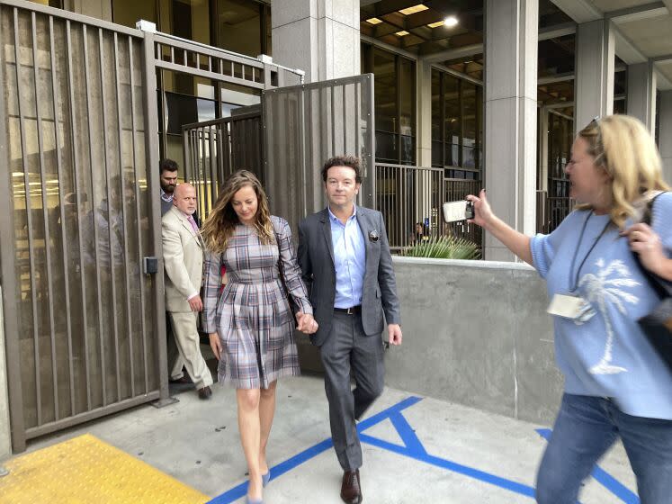 Actor Danny Masterson leaves Los Angeles superior Court with his wife Bijou Phillips after a judge declared a mistrial in his rape case in Los Angeles on Wednesday, Nov. 30, 2022. Jurors said they were hopelessly deadlocked at the trial of "That '70s Show" actor who was charged with the rape of three women, including a former girlfriend, between 2001 and 2003. (AP Photo/Brian Melley)