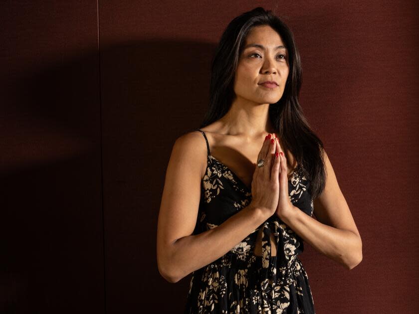 A woman holding her hands in prayer