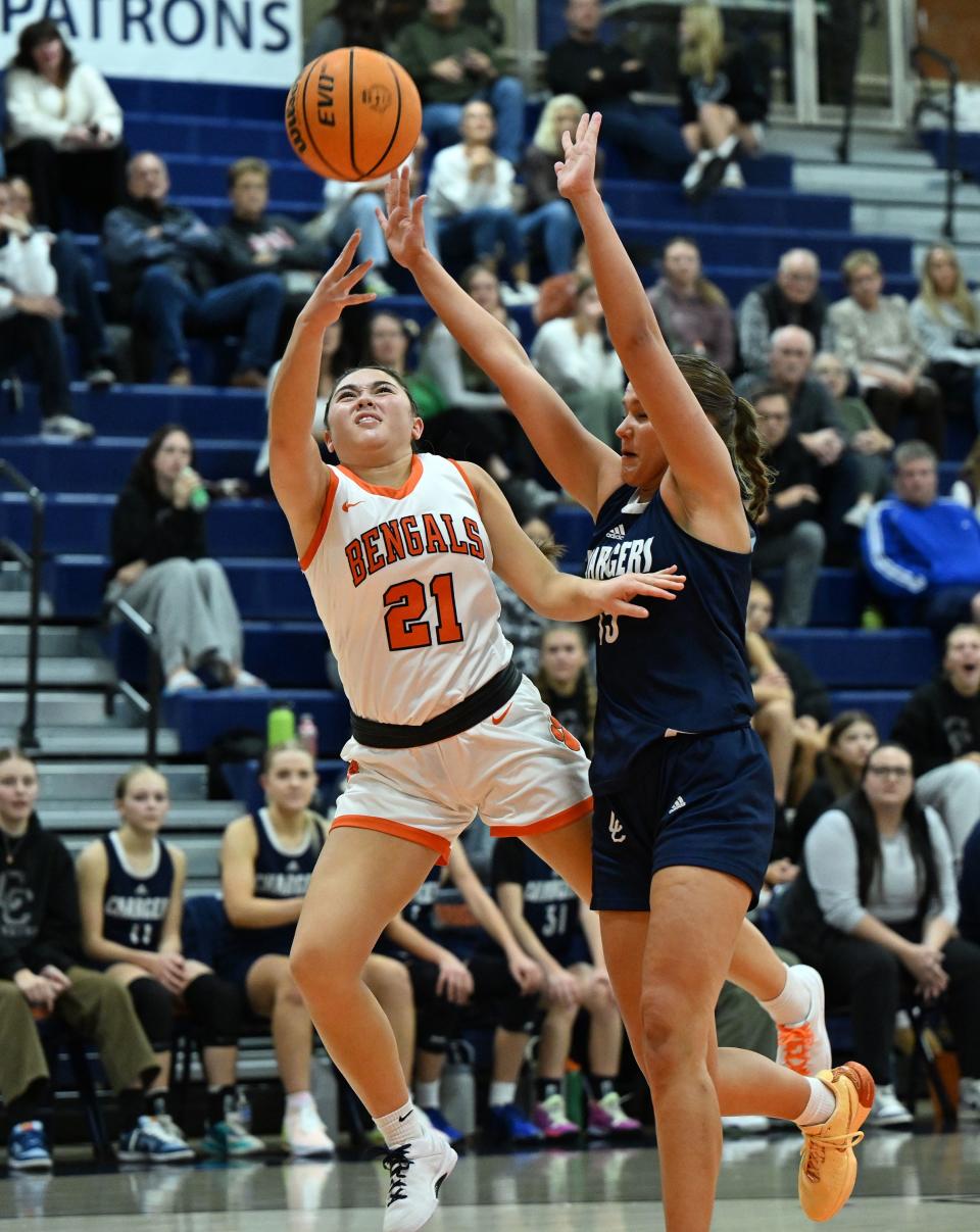Brighton’s Lucy Chin is fouled by Corner Canyon’s Sorrelle Nielsen as she flips the ball toward the basket as they play at Brighton in Cottonwood Heights on Wednesday, Dec. 6, 2023. Brighton won 54-51. | Scott G Winterton, Deseret News