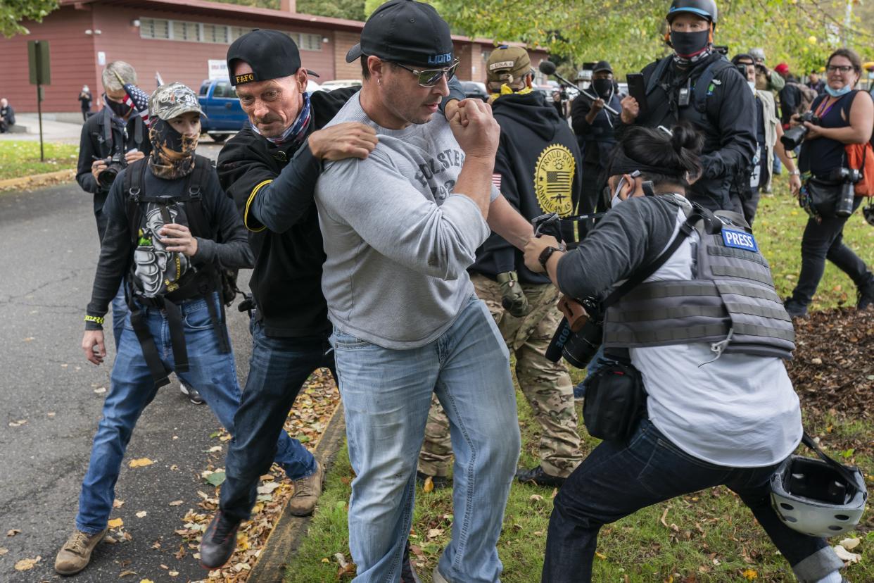 A member of the Proud Boys tackles a fellow member after he assaulted freelance journalist during a Proud Boy rally on September 26, 2020 in Portland, Oregon  (Getty Images)