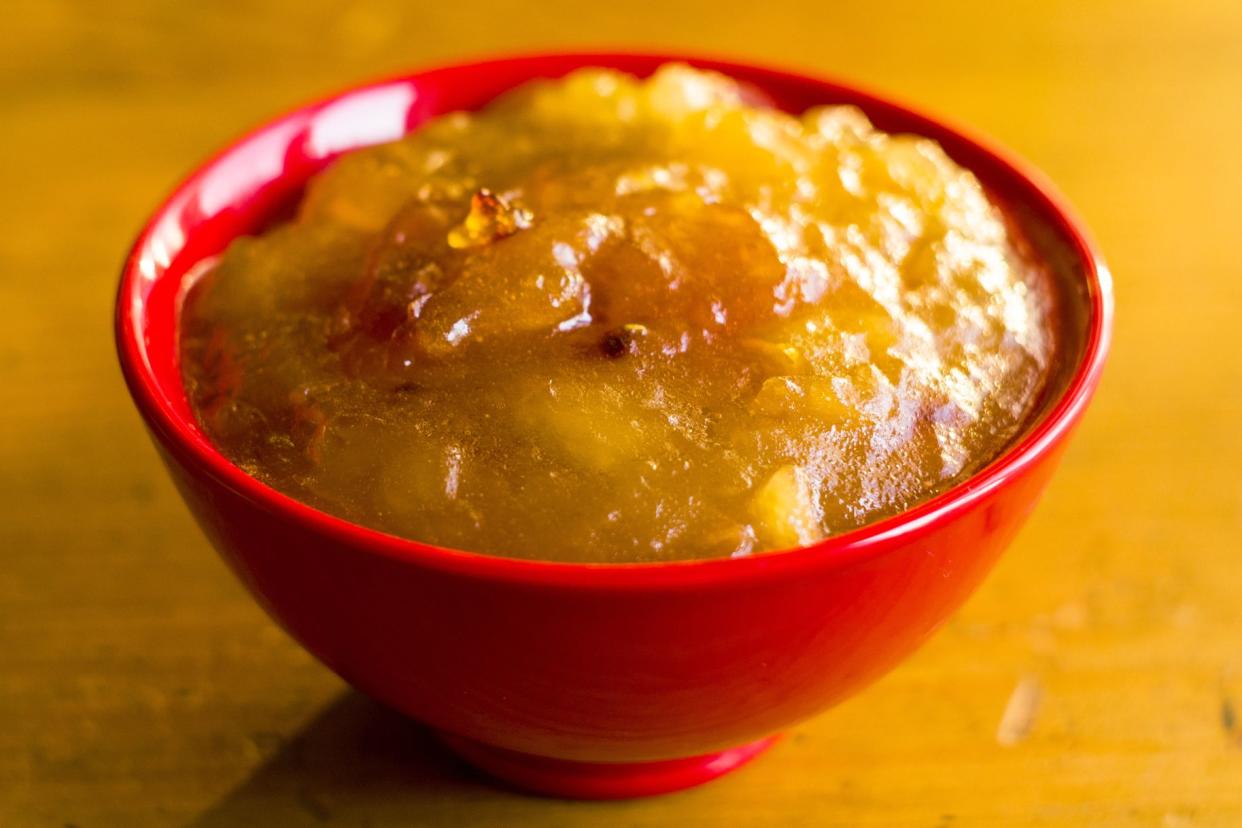 close-up of golden jam in yellow bowl