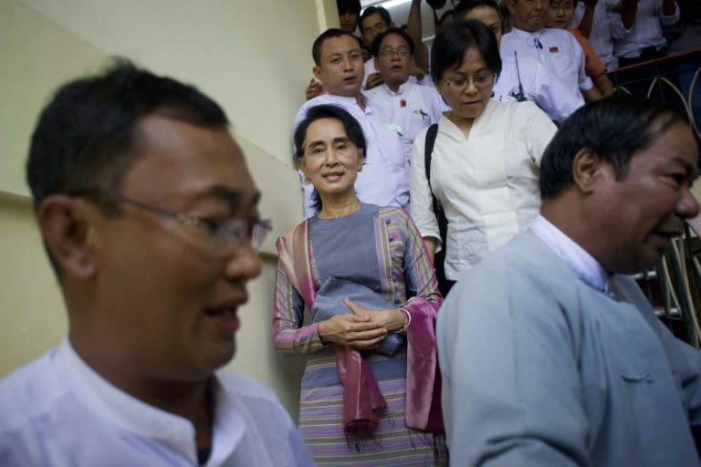 National League for Democracy chairperson Aung San Suu Kyi (centre) leaves the Yangon district court on July 29, 2015