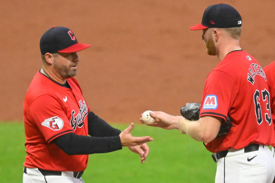 Sep 25, 2024; Cleveland, Ohio, USA; Cleveland Guardians manager Stephen Vogt (12) takes the ball from starting pitcher Andrew Walters (63) during a pitching change in the first inning against the Cincinnati Reds at Progressive Field. Mandatory Credit: David Richard-Imagn Images