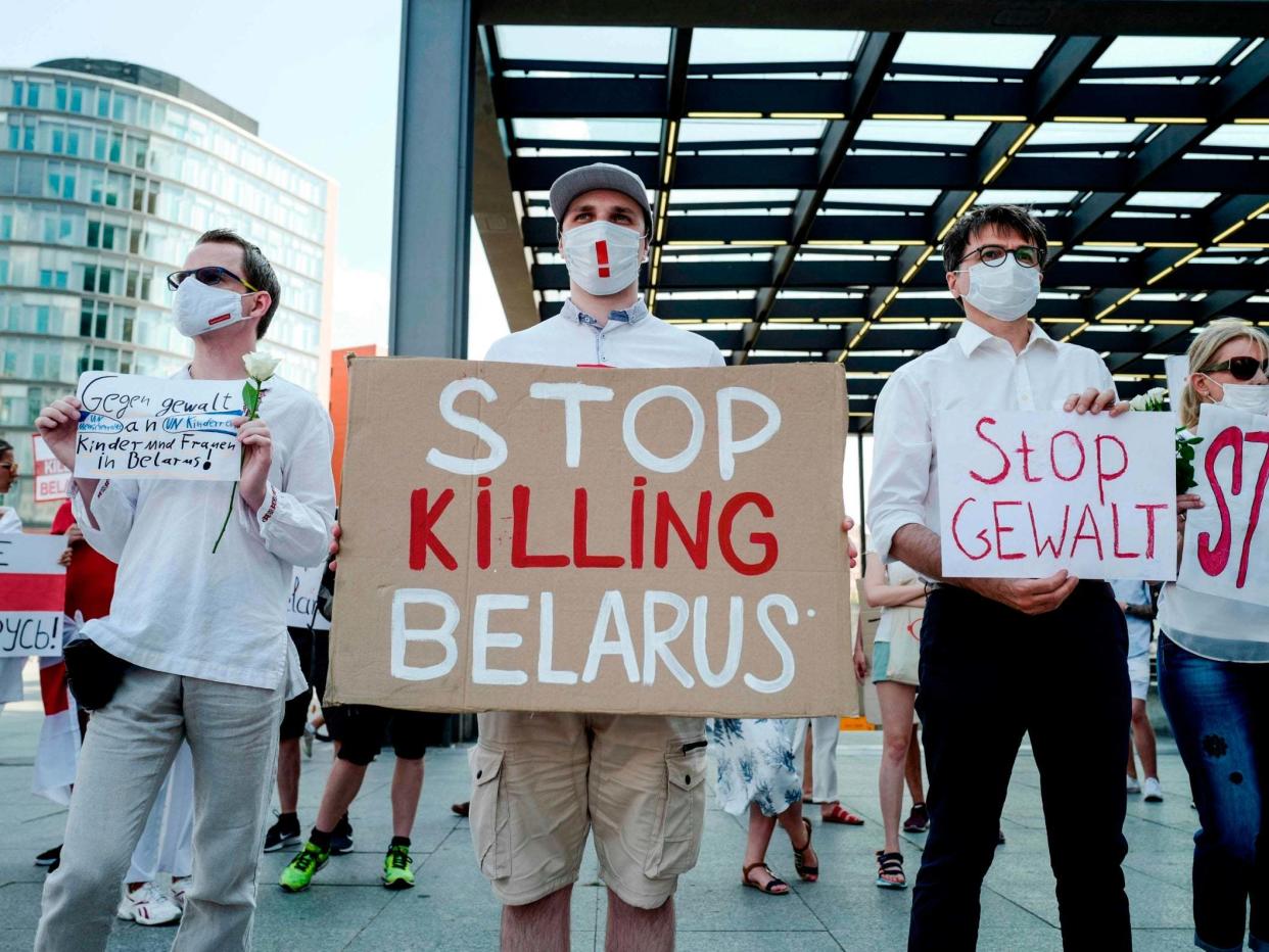 A protester holds a sign reading "Stop Killing Belarus" during a demonstration on the contested elections in Belarus: AFP via Getty Images