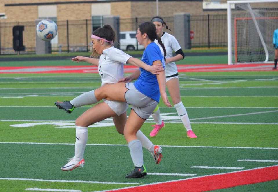 Bedford's Madden Mosley battles for the ball Tuesday. The Mules wore blue jerseys for autism awareness during a 4-1 loss to Ann Arbor Huron.