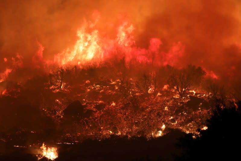 A wildfire dubbed the Cave Fire burns in the hills of Santa Barbara, California,