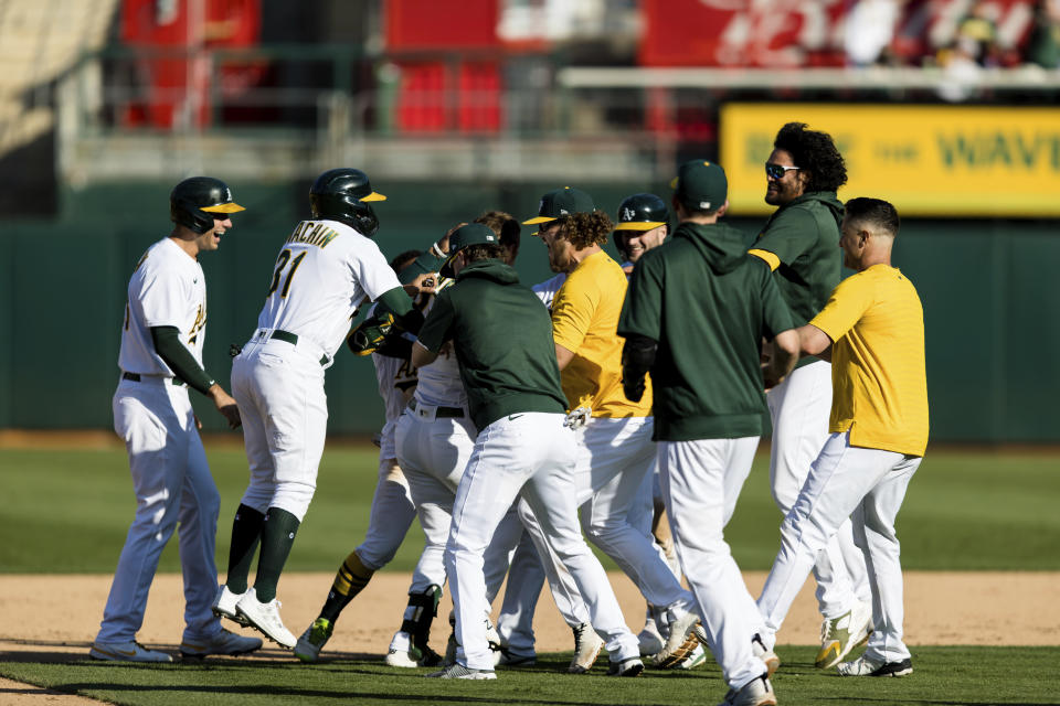 Oakland Athletics players celebrate defeating the Houston Astros after a baseball game in Oakland, Calif., Sunday, Sept. 26, 2021. The Athletics won 4-3. (AP Photo/John Hefti)