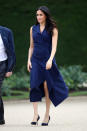 <p>After a 516-mile flight to Melbourne, Meghan appeared wearing a navy, asymmetric dress by Australian designer Dion Lee. The £666 dress isn’t yet available to buy, but <a rel="nofollow noopener" href="https://global.dionlee.com/shop/dion-lee/dresses" target="_blank" data-ylk="slk:bookmark the link;elm:context_link;itc:0;sec:content-canvas" class="link ">bookmark the link</a> for when it is. She covered up in a £1287 Martin Grant trench. <em>[Photo: Getty]</em> </p>