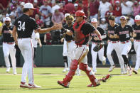North Carolina State pitcher Evan Justice (34) celebrates with catcher Luca Tresh, front right, after defeating Arkansas in an NCAA college baseball super regional game Saturday, June 12, 2021, in Fayetteville, Ark. (AP Photo/Michael Woods)