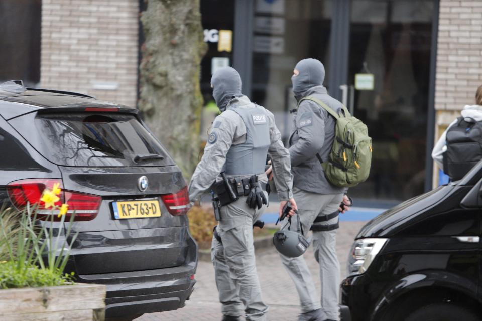 Armed police officers walk near the Cafe Petticoat, where several people were being held hostage (Luciano de Graaf via REUTERS)