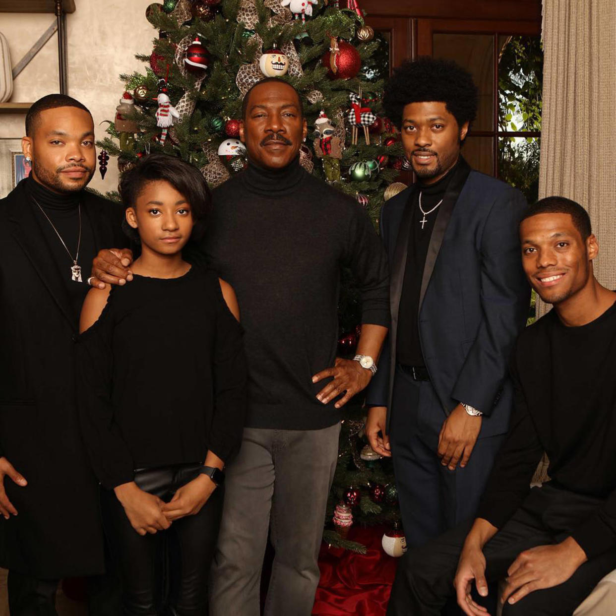 Christian Murphy posing at the holidays with several of his siblings and his father, Eddie Murphy. (Christian Murphy / Instagram)