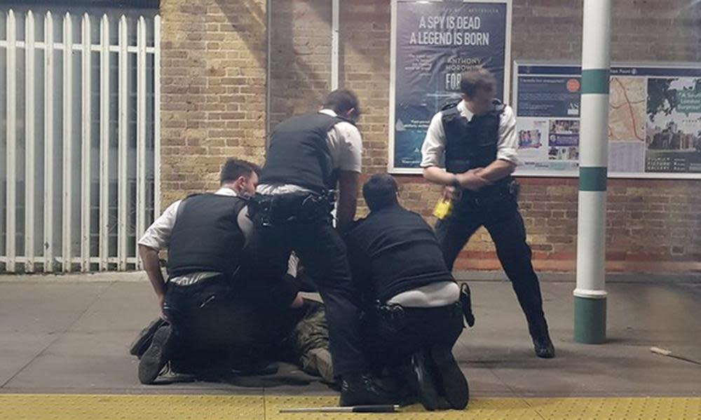 Police arrest the man at Tulse Hill station, south London.