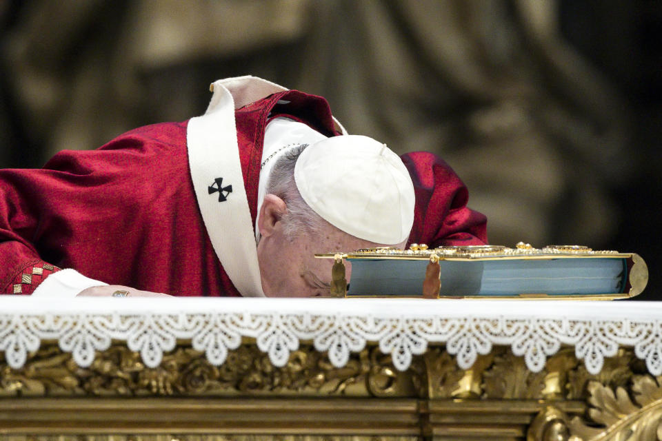 Pope Francis kisses the altar as he celebrates Mass during the Solemnity of Saints Peter and Paul, in St. Peter's Basilica at the Vatican, Monday, June 29, 2020. Francis also blessed the Pallia for the metropolitan archbishops appointed during the year. (Angelo Carconi/Pool Photo via AP)