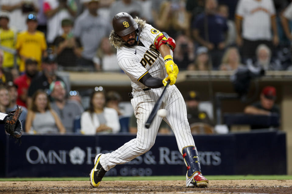 San Diego Padres' Jorge Alfaro hits a two-run single in the ninth inning of the team's baseball game against the Arizona Diamondbacks on Tuesday, Sept. 6, 2022, in San Diego. (AP Photo/Brandon Sloter)