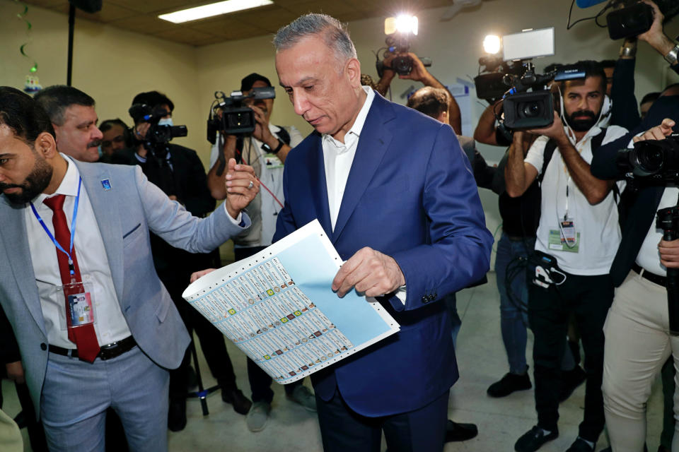 Iraqi Prime Minister Mustafa al-Kadhimi casts his vote during parliamentary elections in Baghdad, Iraq, Sunday, Oct. 10, 2021. Iraq closed its airspace and land border crossings on Sunday as voters headed to the polls to elect a parliament that many hope will deliver much needed reforms after decades of conflict and mismanagement. (AP Photo/Khalid Mohammed)