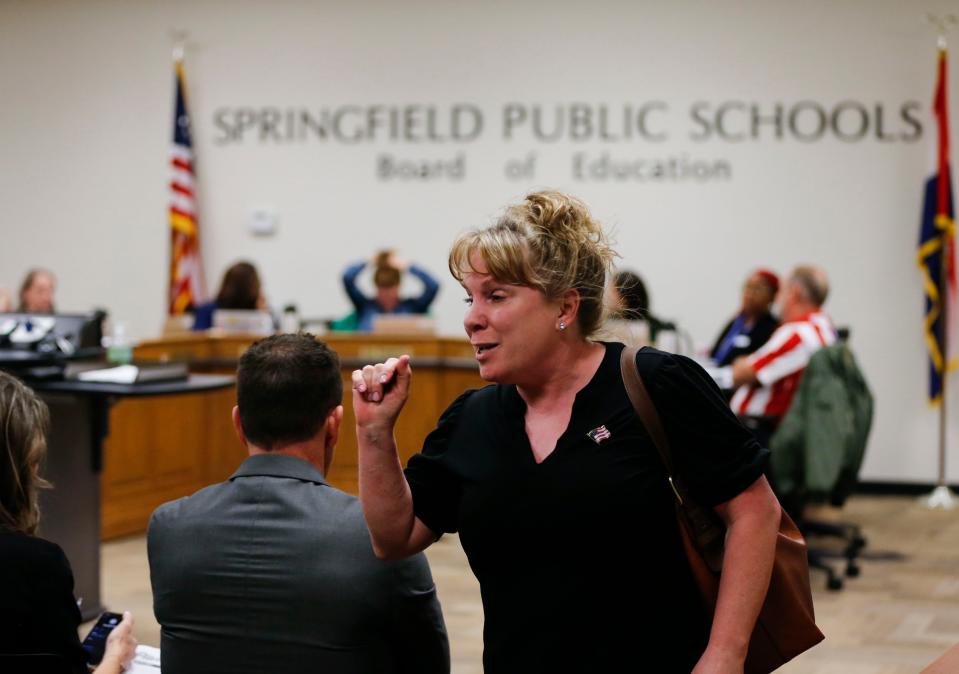 A woman makes comments to audience members as she interrupts and leaves the SPS school board meeting on Tuesday, Feb. 28, 2023.