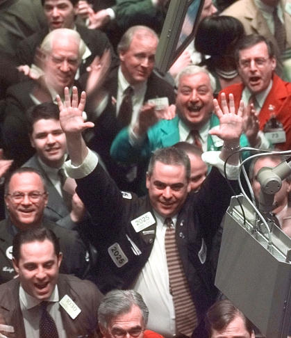 Traders cheer at NYSE, March 1999 file photo: Credit AP