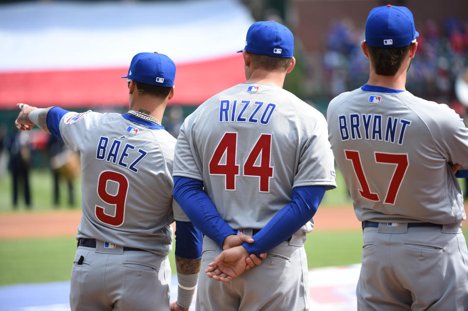 ARLINGTON, TX - MARCH 28:  Javier Baez #9, Anthony Rizzo #44 and Kris Bryant #17 of the Chicago Cubs are seen during player introductions before the game between the Chicago Cubs and the Texas Rangers at Globe Life Park in Arlington on Thursday, March 28, 2019 in Arlington, Texas. (Photo by Cooper Neill/MLB via Getty Images)