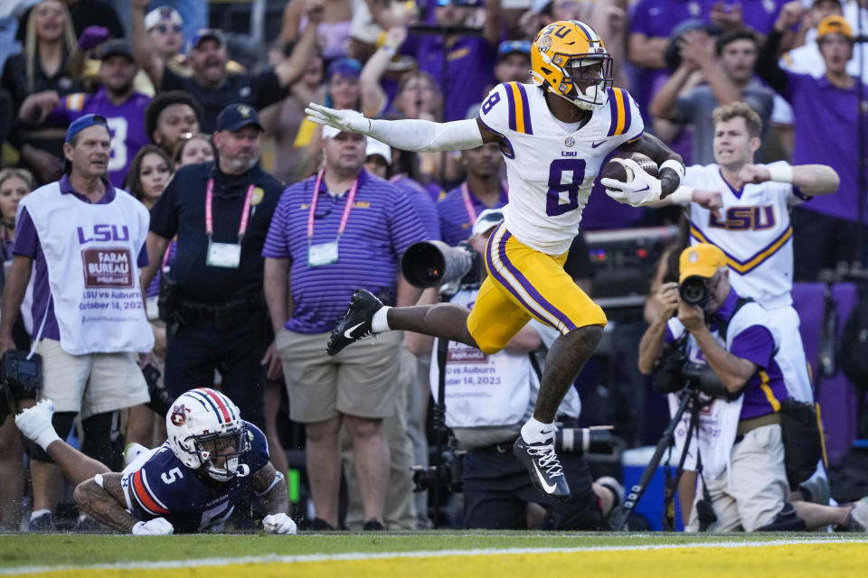 LSU wide receiver Malik Nabers (8) carries for a touchdown past Auburn safety Donovan Kaufman (5) in the first half of an NCAA college football game in Baton Rouge, La., Saturday, Oct. 14, 2023. (AP Photo/Gerald Herbert)