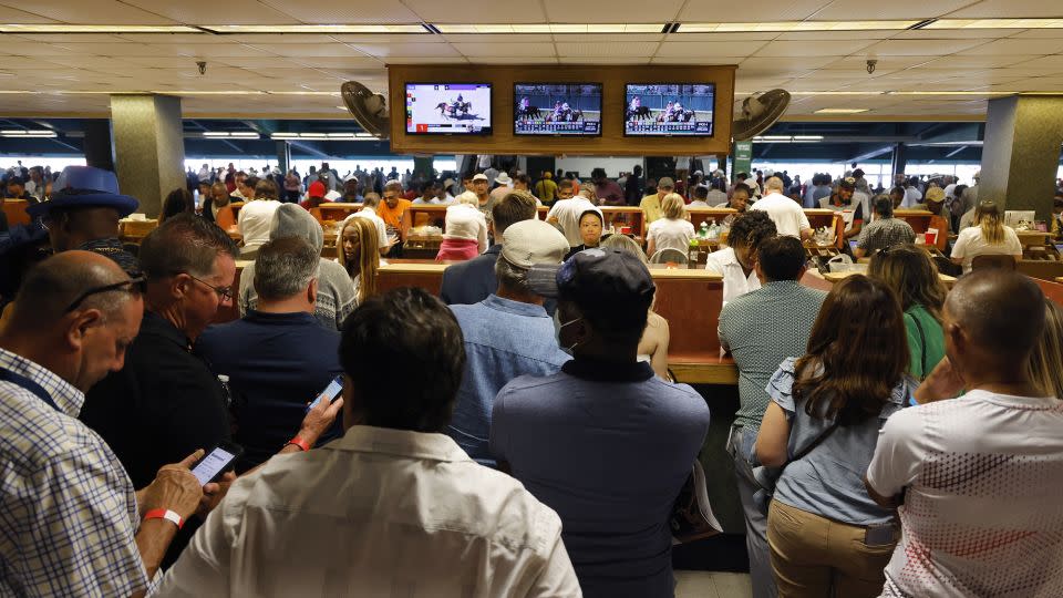 Fans line up at the betting booth prior to the 155th running of the Belmont Stakes at Belmont Park in 2023. - Al Bello/Getty Images