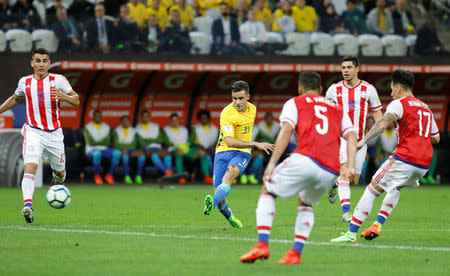 Football Soccer - Brazil v Paraguay - World Cup 2018 Qualifiers - Arena Corinthians stadium, Sao Paulo, Brazil - 28/3/17 - Brazil's Philippe Coutinho (in yellow) scores a goal against Paraguay. REUTERS/Nacho Doce