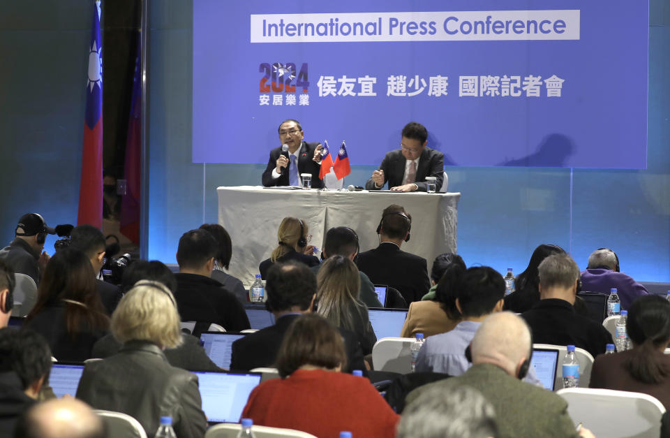 Taiwan's Nationalist Party presidential candidate Hou Yu-ih, left, answers to press with his running mate Jaw Shau-kong during an international press conference in New Taipei, Taiwan, Thursday, Jan. 11, 2024. Taiwan will hold its presidential election on Jan. 13. (AP Photo/Chiang Ying-ying)