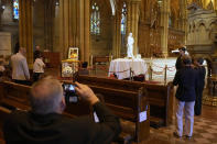 The coffin of Cardinal George Pell lays in state at St. Mary's Cathedral in Sydney, Wednesday, Feb. 1, 2023. Mourners paid their respects to Cardinal George Pell who lay in state in a Sydney cathedral on Wednesday as police sought a court order to prevent protesters from disrupting his funeral. (AP Photo/Rick Rycroft, Pool)