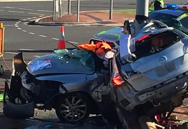 The wreckage of the allegedly stolen car, wrapped around a pole in Rothwell, north of Brisbane.