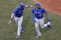 Toronto Blue Jays' Marcus Semien, right, celebrates his two-run home run that also drove in Reese McGuire, left, during the fifth inning of a baseball game against the Boston Red Sox, Saturday, June 12, 2021, in Boston. (AP Photo/Michael Dwyer)