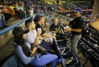 A man sells beer during the opening winter season game between Leones de Caracas and Tigres de Aragua in Caracas, Venezuela, Tuesday, Nov. 5, 2019. Despite a noticeable number of empty seats, the game didn’t disappoint. The Tigers beat the Lions of Caracas 6-3. (AP Photo/Ariana Cubillos)