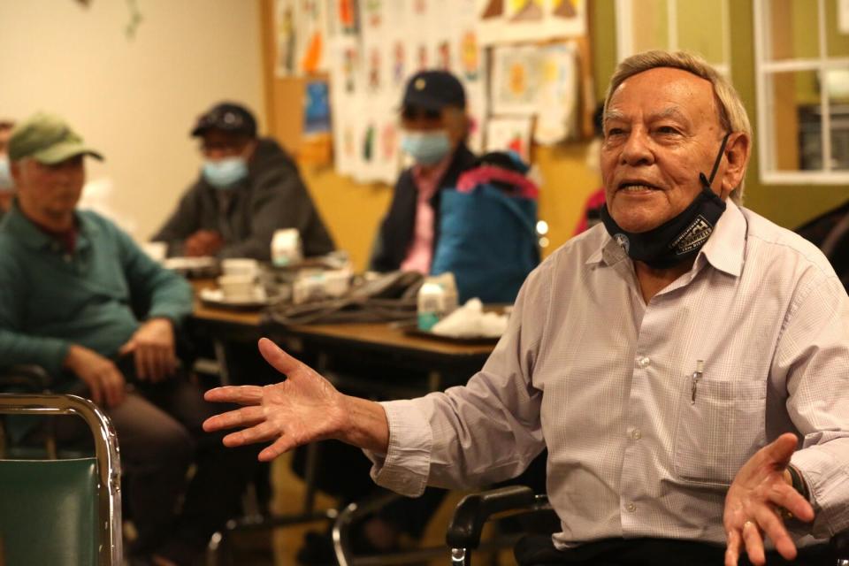 Emiliano Galan, 83, poses a question to LAPD officers and a manager with Adult Protective Services.