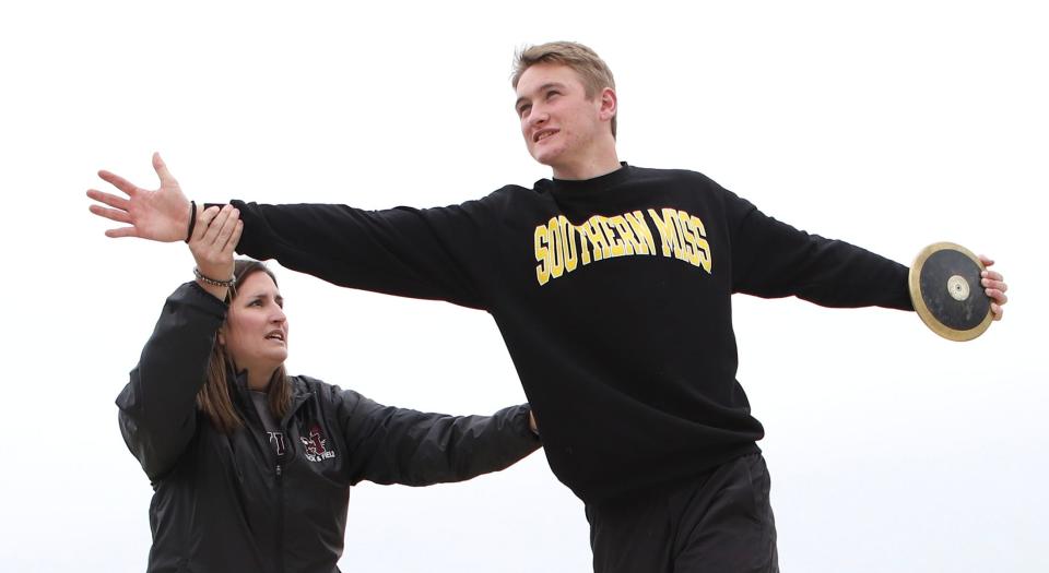 Niceville Throws/Assistant Head Coach Emily Webb works on new techniques with Niceville senior discus thrower SJ Trube. Trube has committed to Southern Mississippi, a remarkable achievement for an athlete who was on the verge of losing his eyesight.