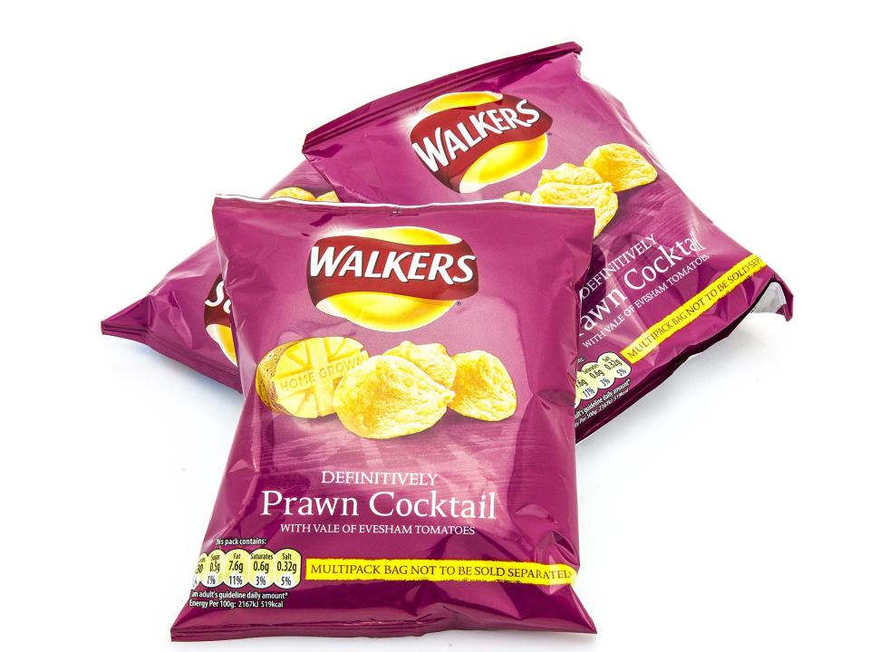 Walkers prawn cocktail crisps pink bags on white background