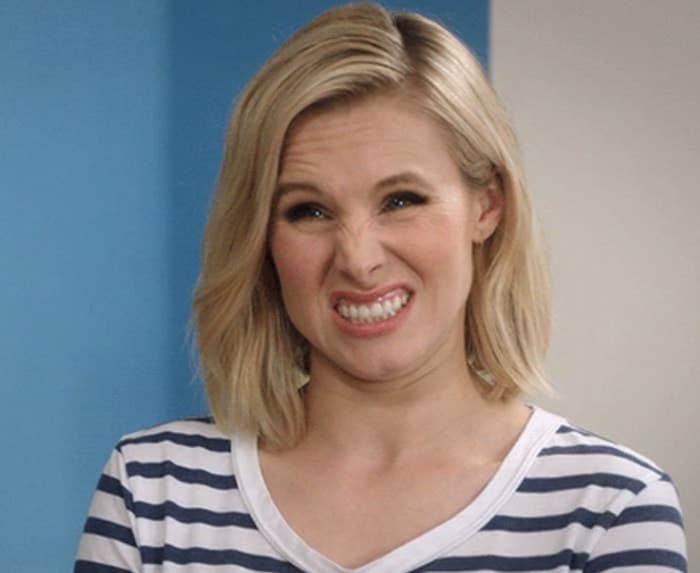 Woman in striped top making a funny face with scrunched nose and smile